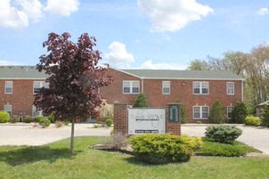 a large brick building with a sign in front of it