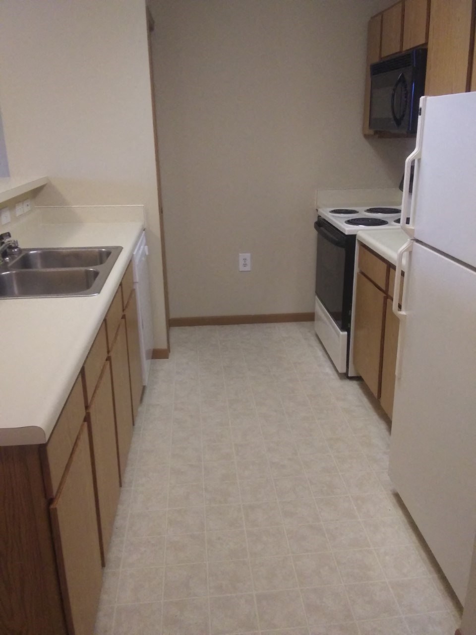 a kitchen with a sink and a refrigerator