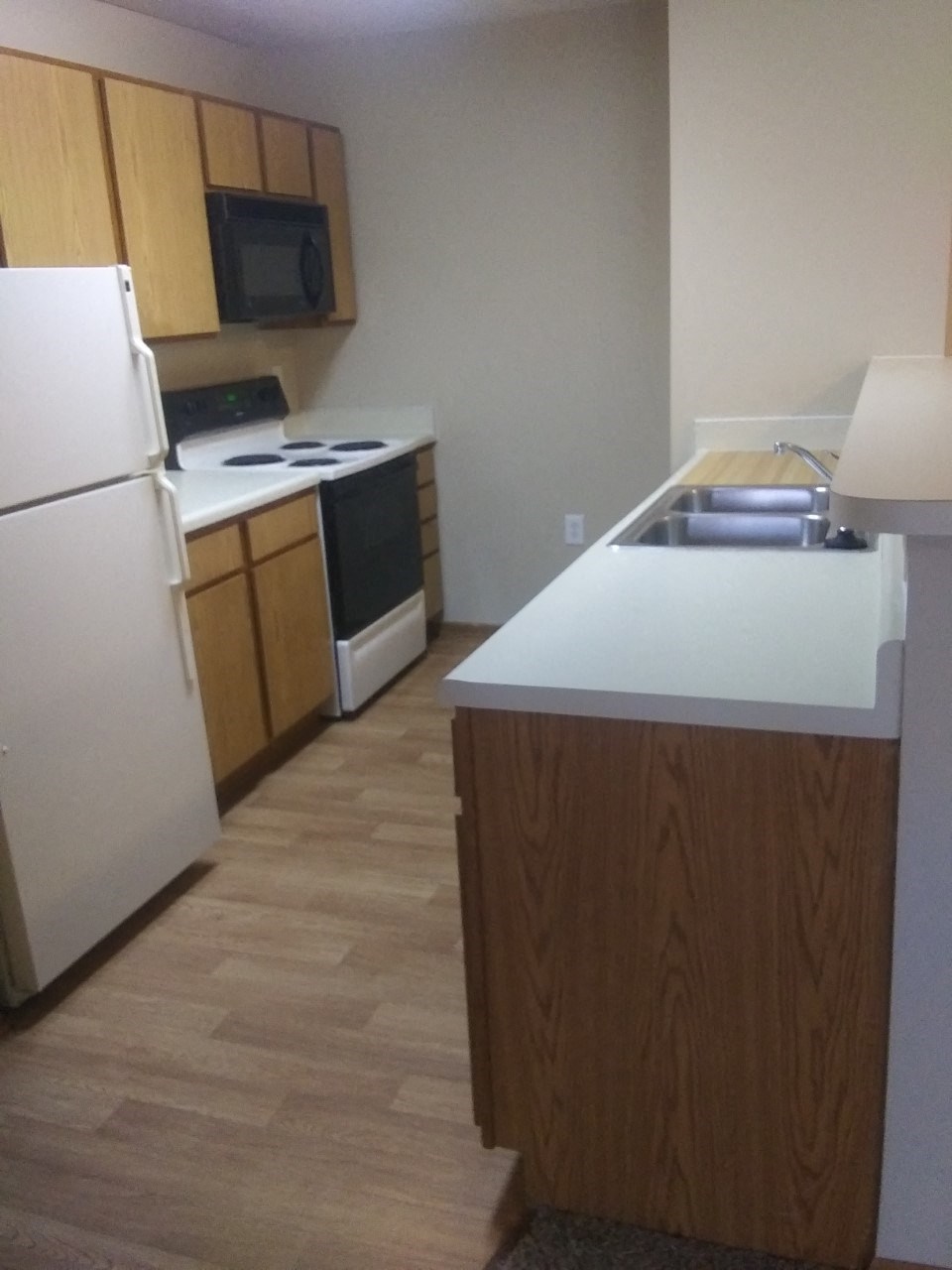 a kitchen with a sink and a refrigerator