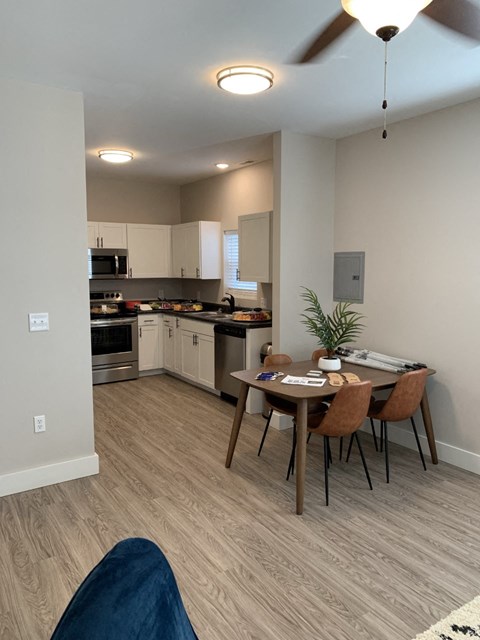 an open kitchen and dining area with a table and chairs