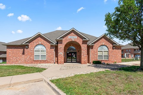 A brick building with the words "Office" written above the entrance.