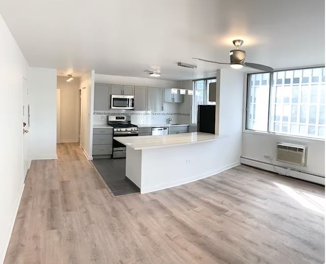 A modern kitchen with a large island and a window.