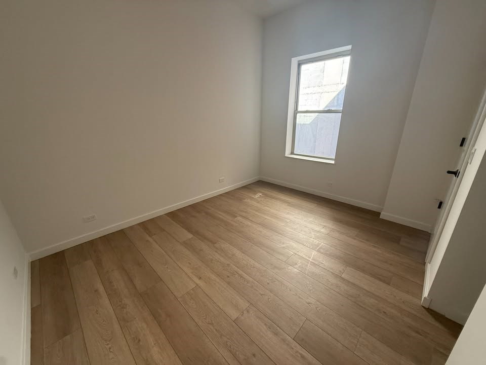 A room with wooden flooring and a window.at The Nest at Lincoln Park West, Illinois, 60614