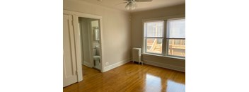 A room with a window and a fan.