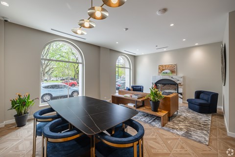 A modern dining room with a large table and chairs.
