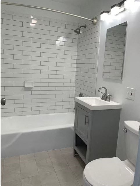 A white toilet sits next to a sink in a bathroom.