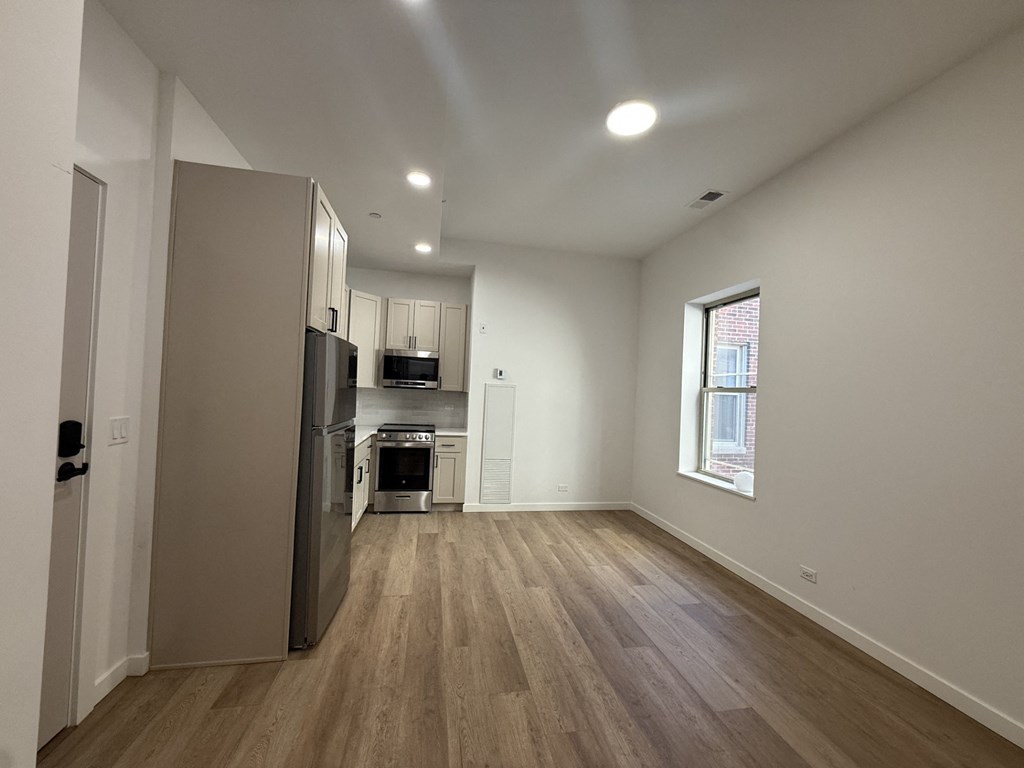 A kitchen with a refrigerator, oven, and sink.at The Nest at Lincoln Park West, Chicago, IL