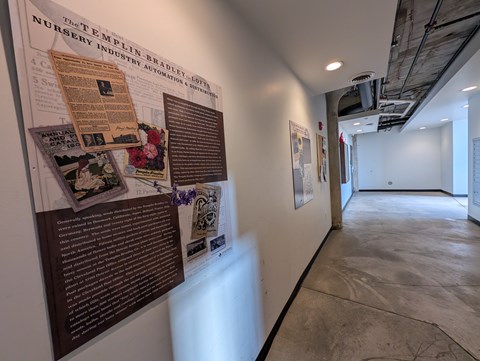 A wall of posters and pictures with a sign that says "The Templin Nursery Industry Automation".