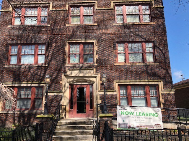a building with a now leasing sign in front of it