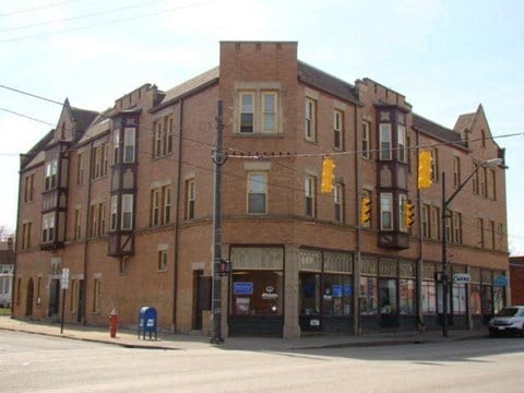 a large brick building on the corner of a street