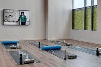 A yoga studio with a large mirror on the wall.