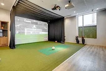 A room with a green mat and a black curtain.