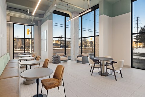 A modern dining area with a table and chairs.