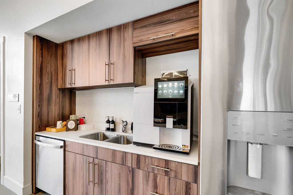 A modern kitchen with wooden cabinets and stainless steel appliances.