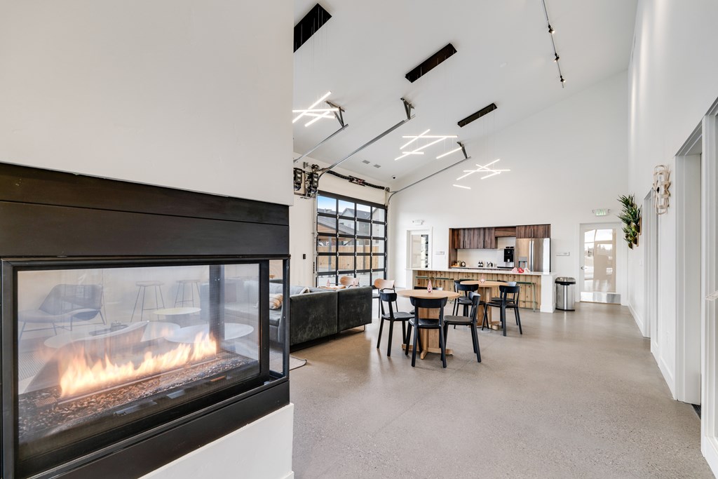 A modern living room with a fireplace and a dining area.