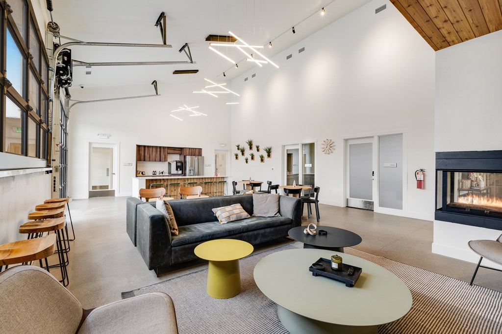 A modern living room with a fireplace and a grey sofa.
