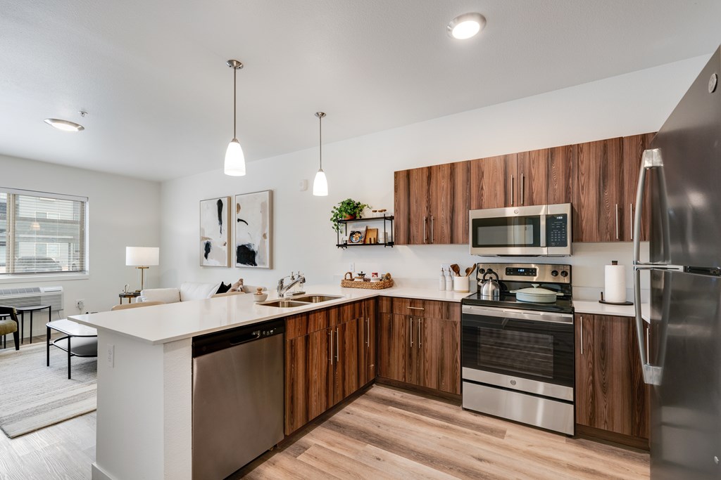 A modern kitchen with wooden cabinets and stainless steel appliances.