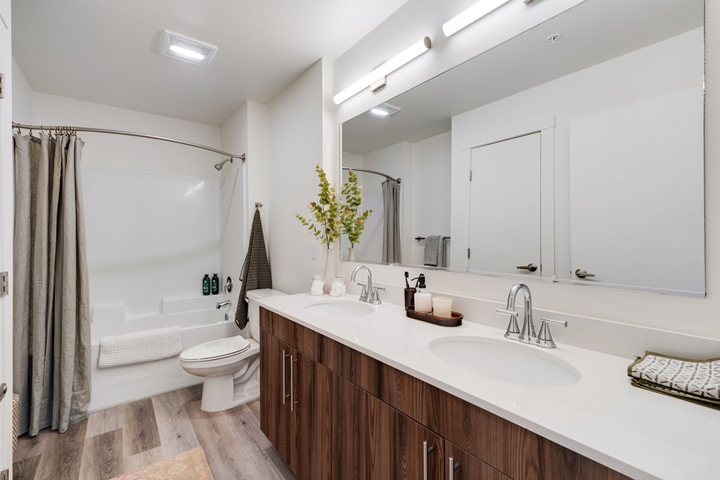 A bathroom with a white sink and a white toilet.