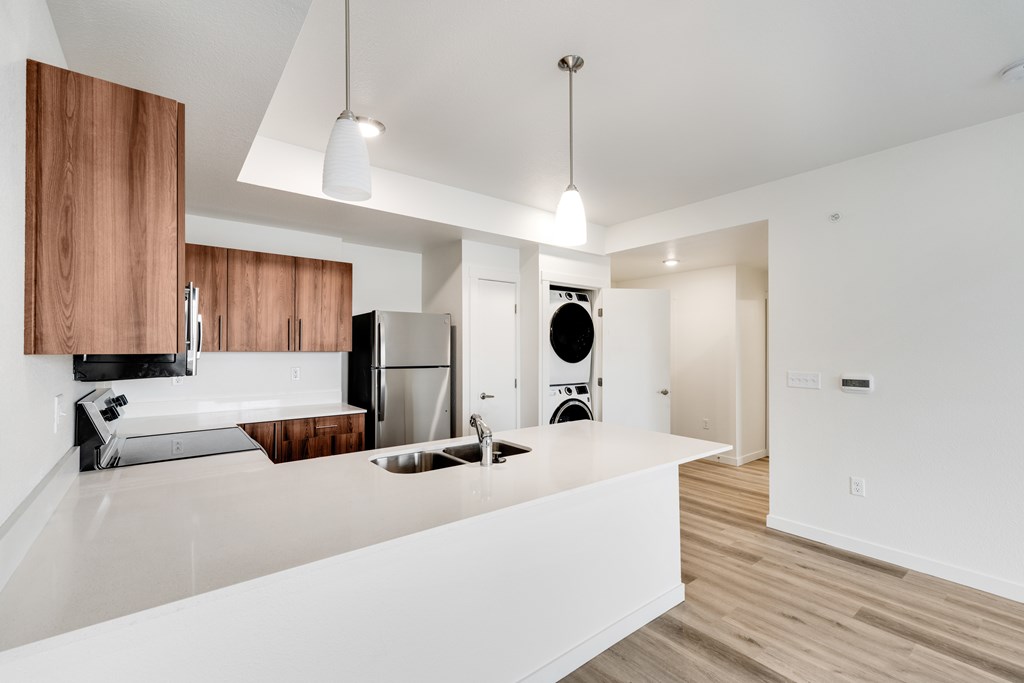 A modern kitchen with wooden cabinets and stainless steel appliances.