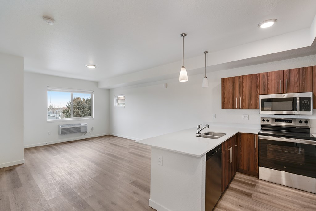 A modern kitchen with wooden cabinets and stainless steel appliances.