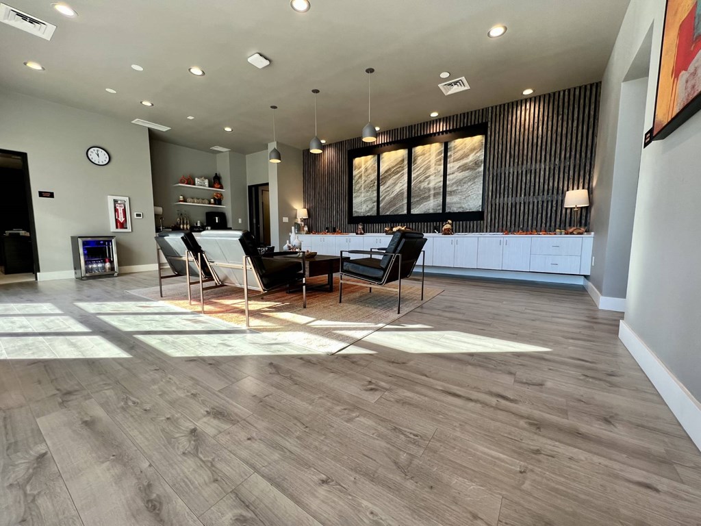 A modern living room with a wooden floor and a large window.