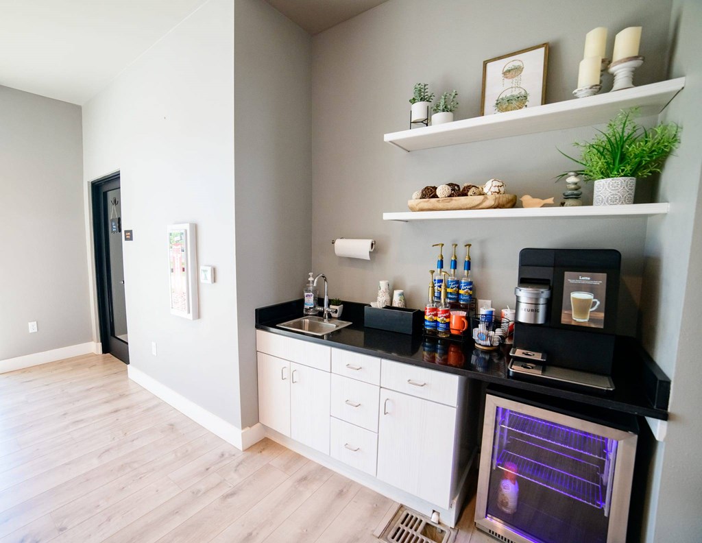 A kitchen with a black countertop and white cabinets.
