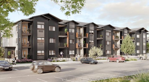 A row of modern apartment buildings with cars parked in front.