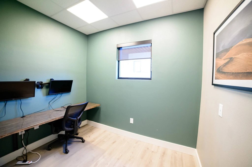 A room with a green wall and a window.