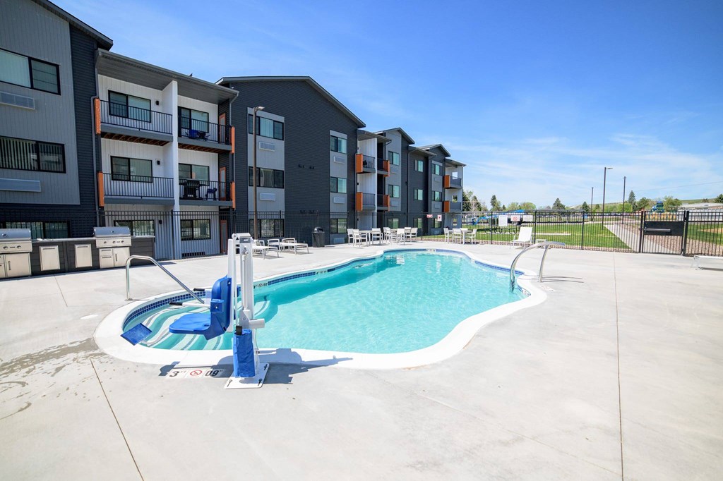 A swimming pool in front of apartment buildings.