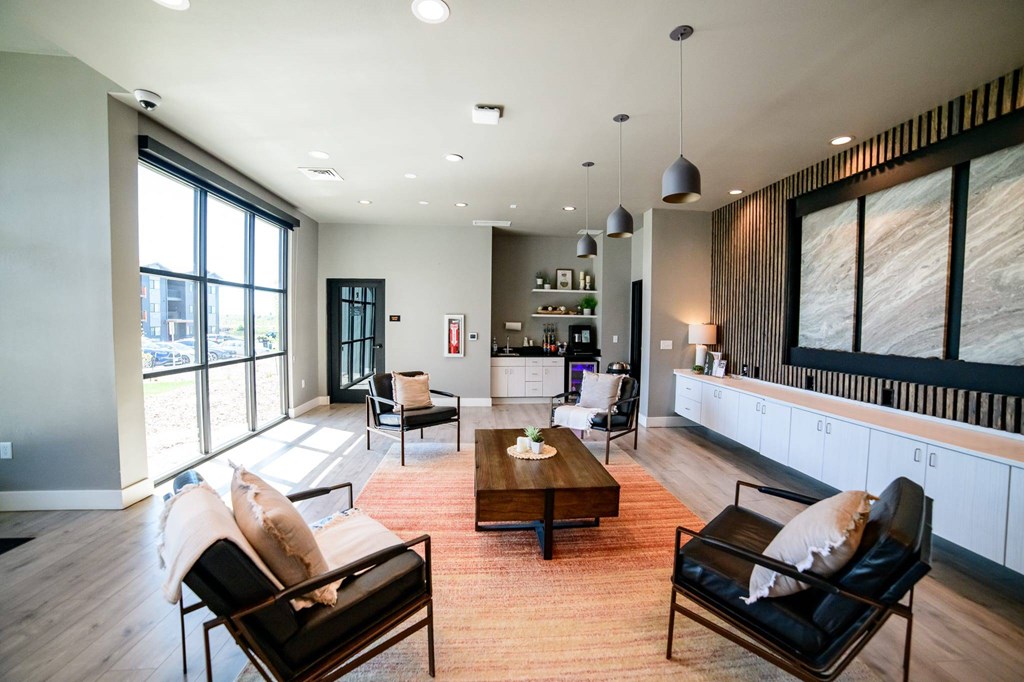 A living room with a black chair and a brown coffee table.