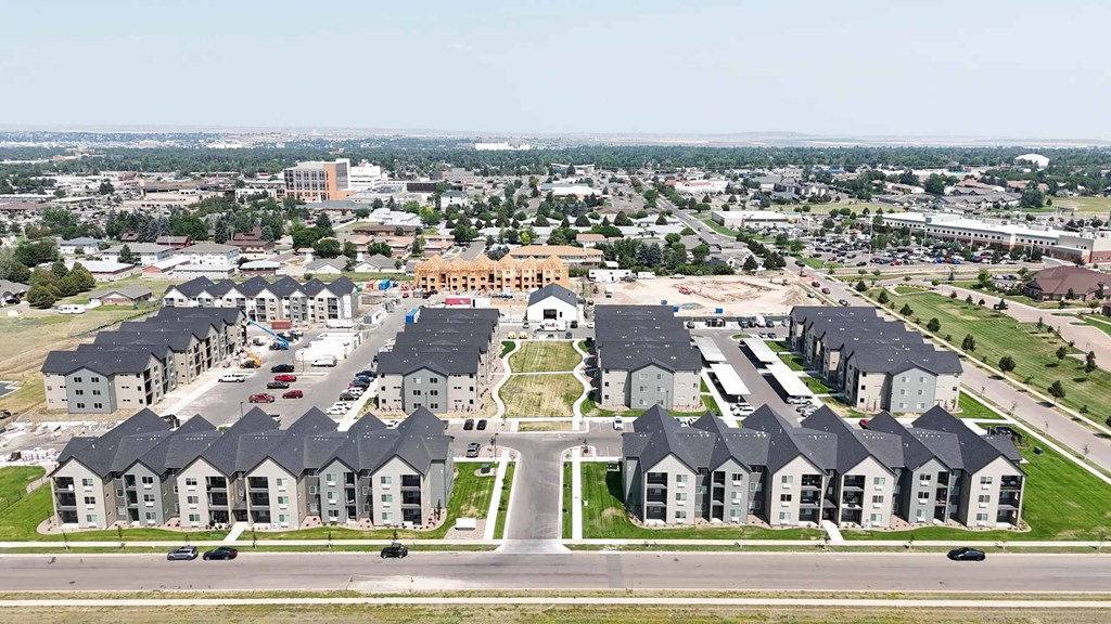 A large housing development with a central open area and roads.