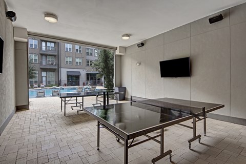 Poolside Outdoor Yard Game Area at Civic at Frisco Square Apartments, Frisco