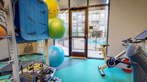 Gym with a blue mat and a variety of equipment including a treadmill at Civic at Frisco Square Apartments, Frisco, TX, 75034