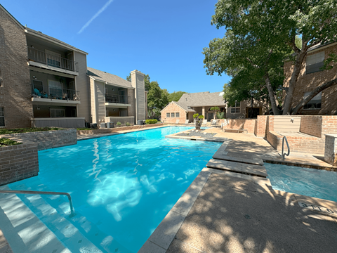 Swimming pool with spa and brick accent walls at Altamonte Apartments, San Antonio, TX