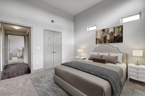 A bedroom with a large bed and a painting on the wall.