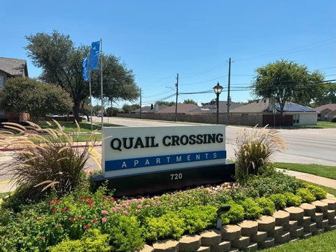 Property entrance monument sign with landscaping at Quail Crossing Apartments, Texas, 75052