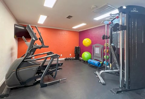 Fitness center with cardio and weight equipment at Autumn Chase Apartments, San Marcos, 78666