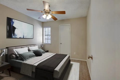 Bedroom with ceiling fan and modern furnishings at Autumn Chase Apartments, San Marcos, Texas