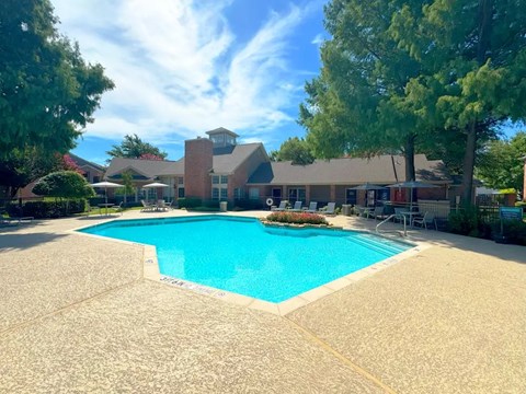 Swimming pool with sundeck and clubhouse at Indian Creek Apartments, Waxahachie