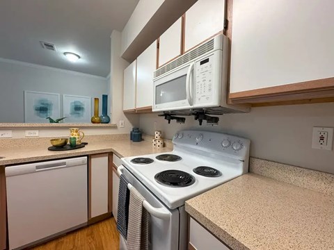 A white stove and microwave in a kitchen.