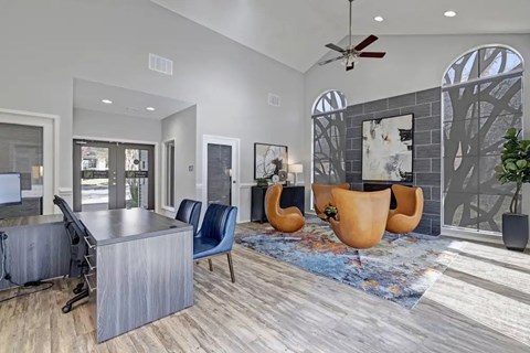 A modern living room with a grey sofa and a wooden table.