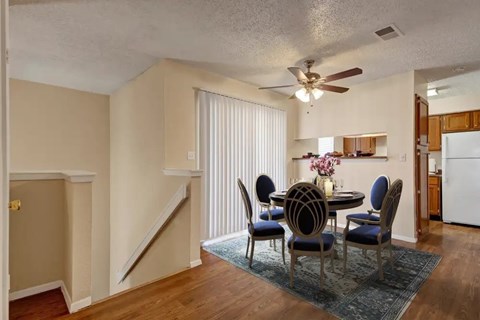 A dining room with a table set for four.