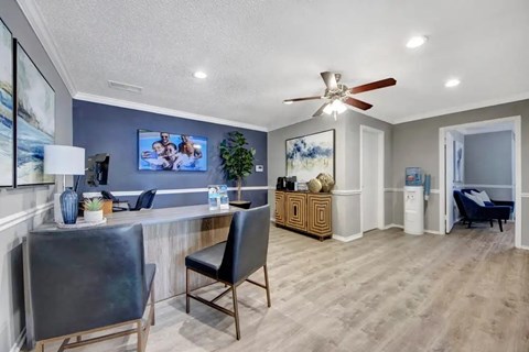 A living room with a ceiling fan and a couch.