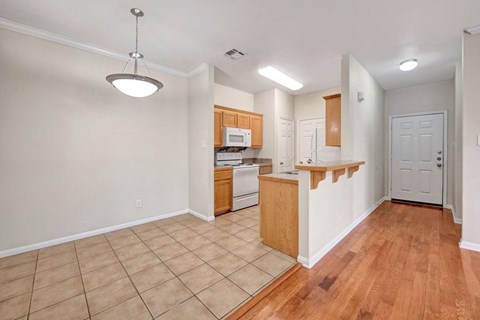 A kitchen with wooden cabinets and a white door.