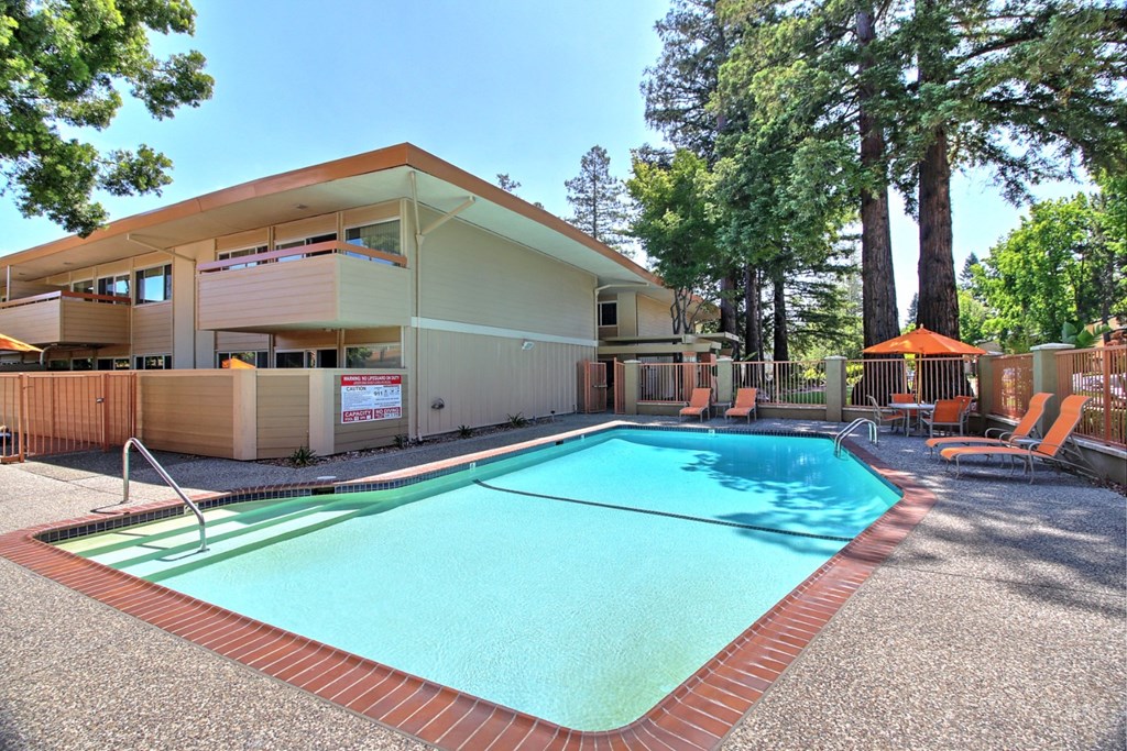a swimming pool with a building in the background