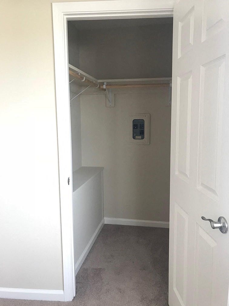an empty closet with a white door