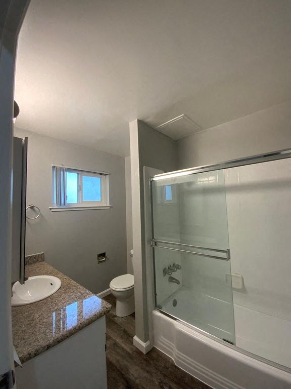A bathroom with a walk-in shower and a toilet.