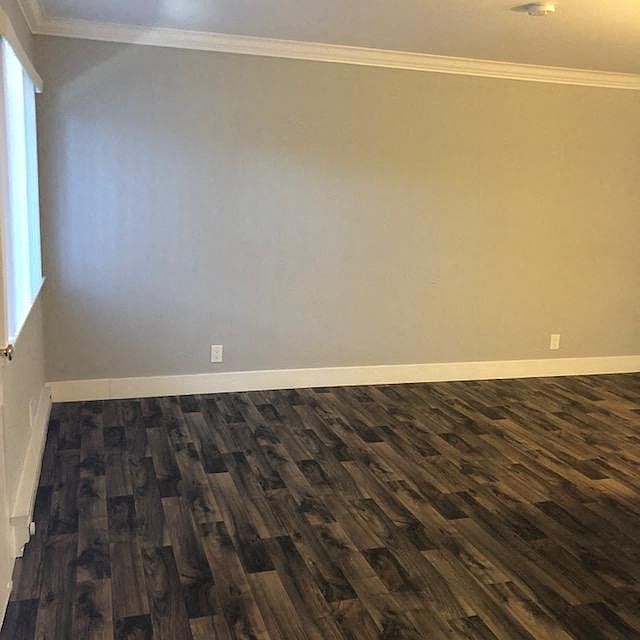 A room with a wooden floor and a white door.
