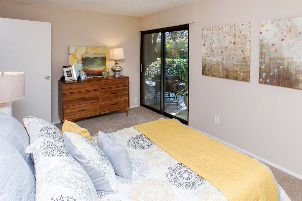 a bedroom with a bed and a dresser