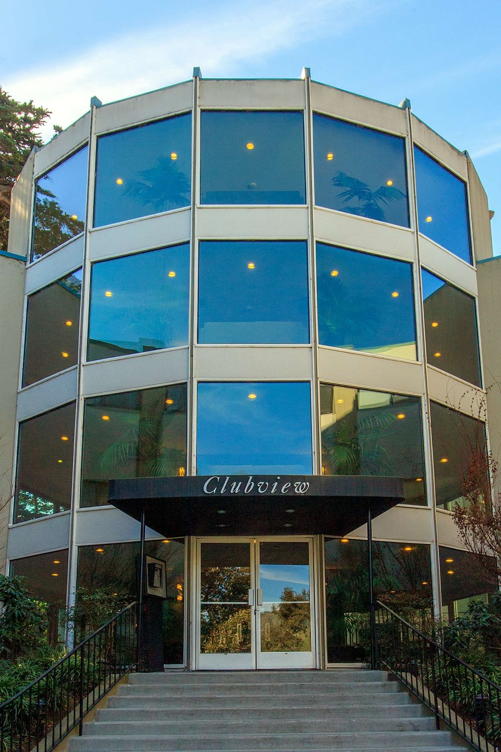 a building with blue windows and a staircase in front of it
